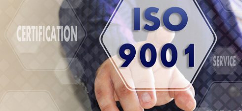 The businessman chooses ISO 9001,  presses a button on the touch screen