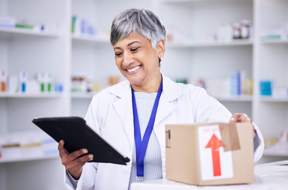 Happy,Woman,,Pharmacist,And,Tablet,In,Logistics,With,Box,For